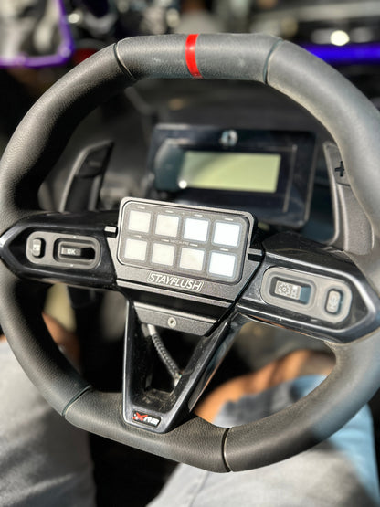 StayFlush Motorsports SFM MaverickR steering wheel switch-pros mount mounted on a steering wheel in a vehicle interior.