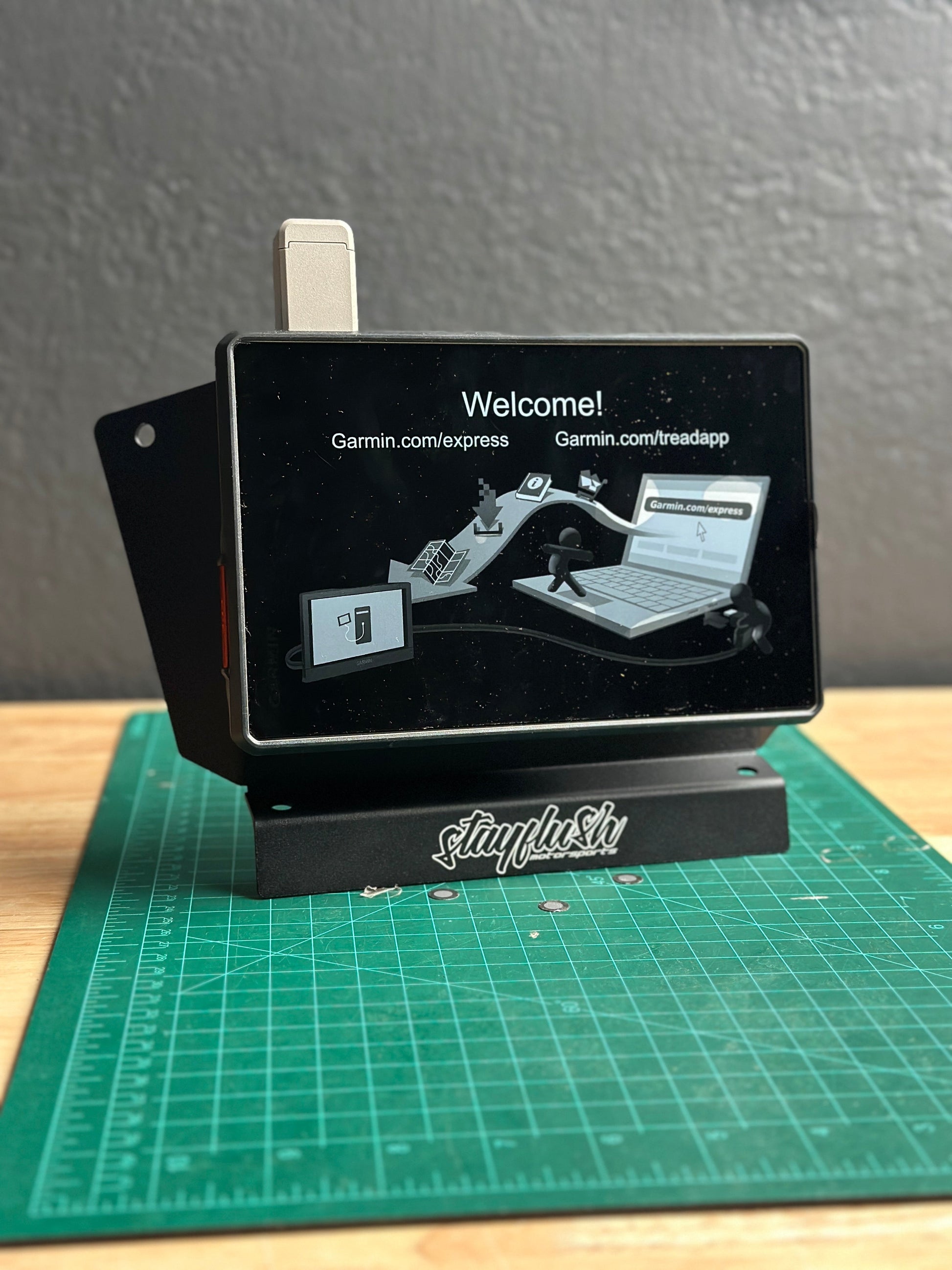 StayFlush Motorsports SFM ProR/XP 25 universal tablet mount attached to a vehicle dashboard with a tablet secured in place.