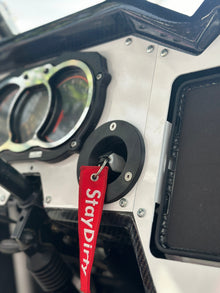 StayFlush Motorsports CanamX3 console key fob mount on black textured surface, designed for secure key storage and easy access.