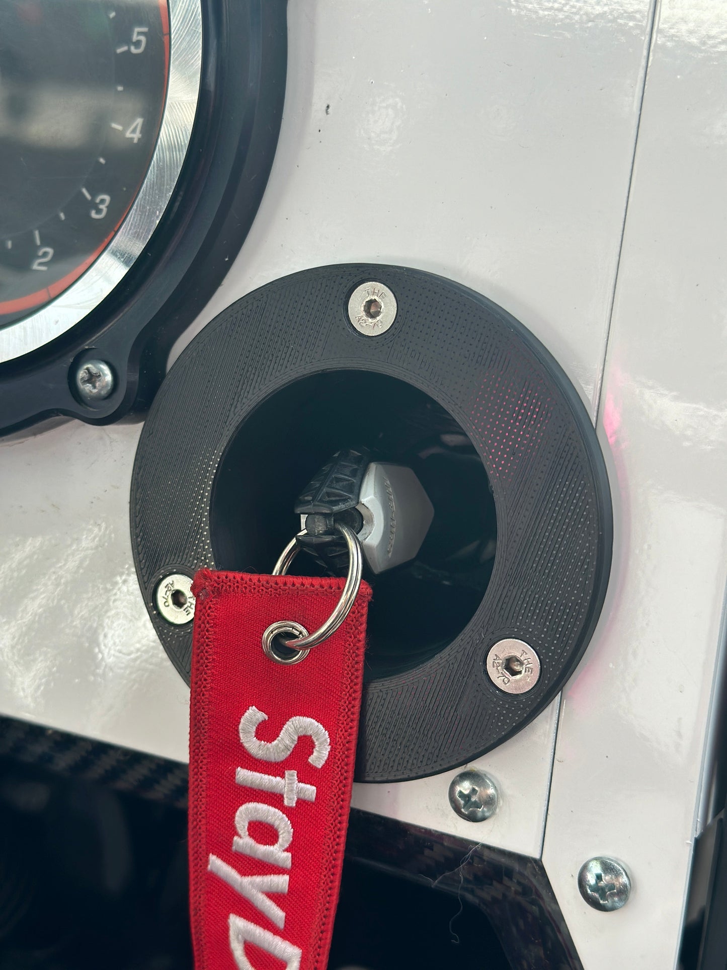 StayFlush Motorsports SFM Key Fob Mount installed in CanamX3 console, providing secure key holder for vehicle.
